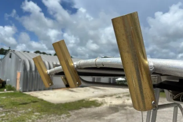 Slide: The Image of Boat rod holders on a 2001 Polar 1780 Flat, with a cloudy sky background. - 25