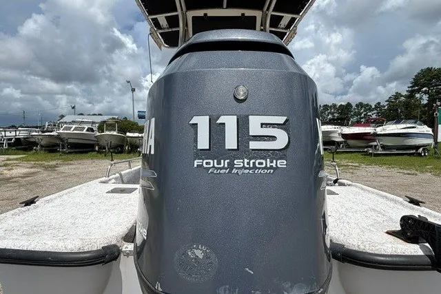 Slide: The Image of Outboard motor on 2001 Polar 1780 Flat boat, Yamaha 115 four-stroke engine, in a marina setting. - 26