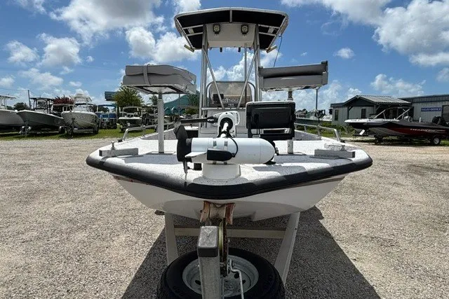 Slide: The Image of 2001 Polar 1780 Flat boat on trailer under blue sky at marina. - 2