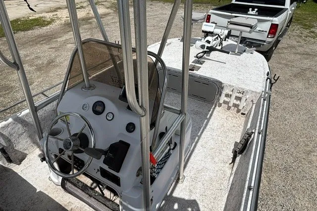 Slide: The Image of 2001 Polar 1780 Flat boat with steering console, parked near a white pickup truck. - 15