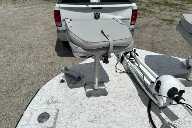 Slide: The Image of 2001 Polar 1780 Flat boat with seat and trolling motor, parked behind a white truck. - 17