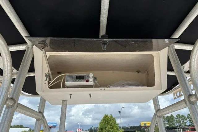 Slide: The Image of Open storage compartment on a 2001 Polar 1780 Flat boat, featuring a radio device. - 24