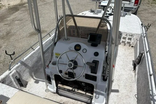Slide: The Image of 2001 Polar 1780 Flat boat interior with steering wheel and control panel. - 12