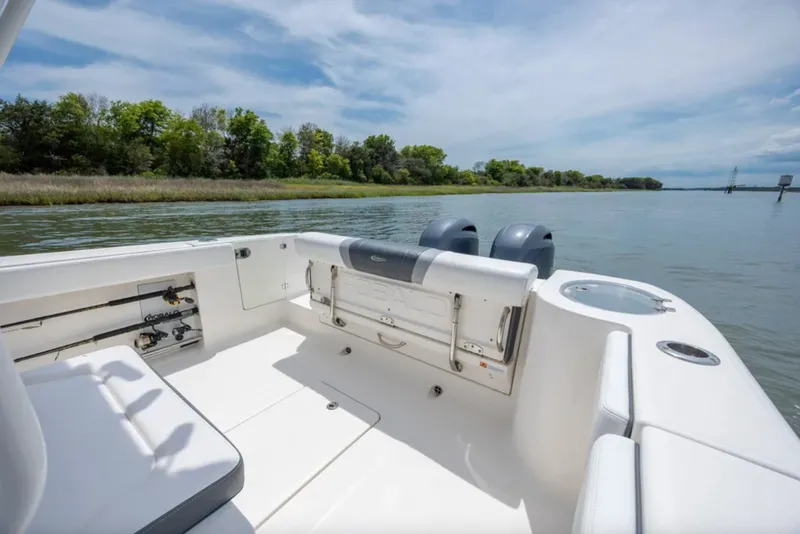 Slide: The Image of 2021 Robalo R272 Center Console boat on calm water, featuring spacious seating and dual engines. - 15