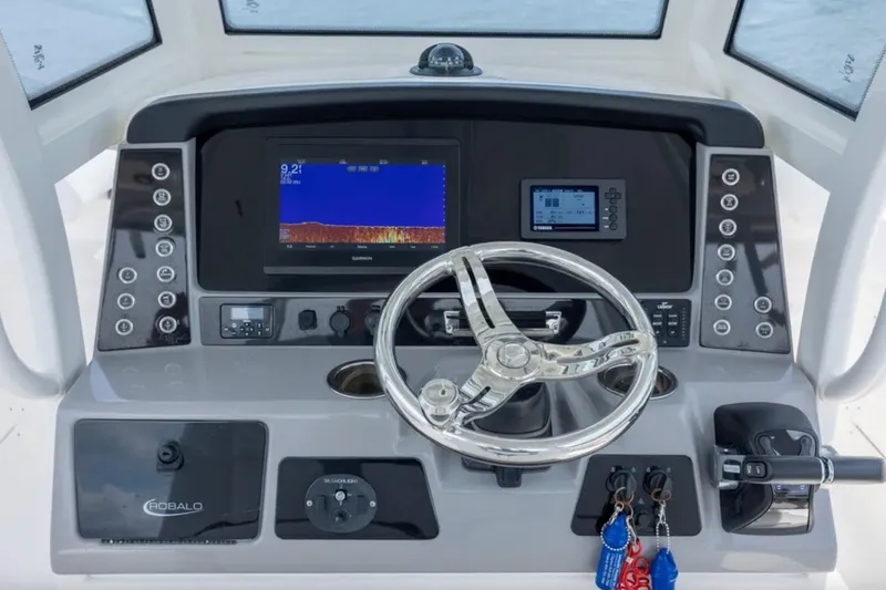 Slide: The Image of 2021 Robalo R272 Center Console dashboard with steering wheel and navigation displays. - 9