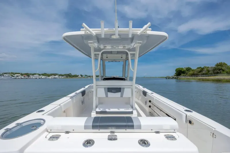 Slide: The Image of 2021 Robalo R272 Center Console boat on calm water under blue sky. - 6