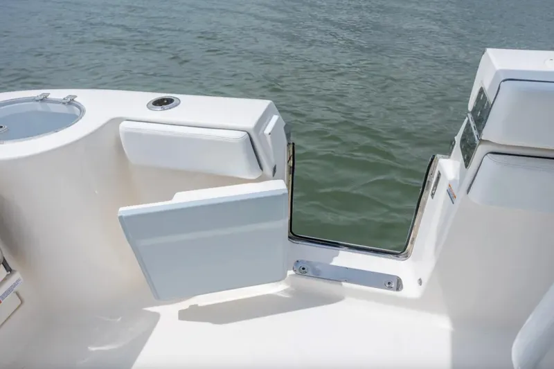 Slide: The Image of 2021 Robalo R272 Center Console boat with open side door on water. - 12