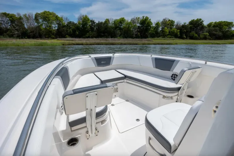 Slide: The Image of 2021 Robalo R272 Center Console boat interior with seating, on calm water. - 13
