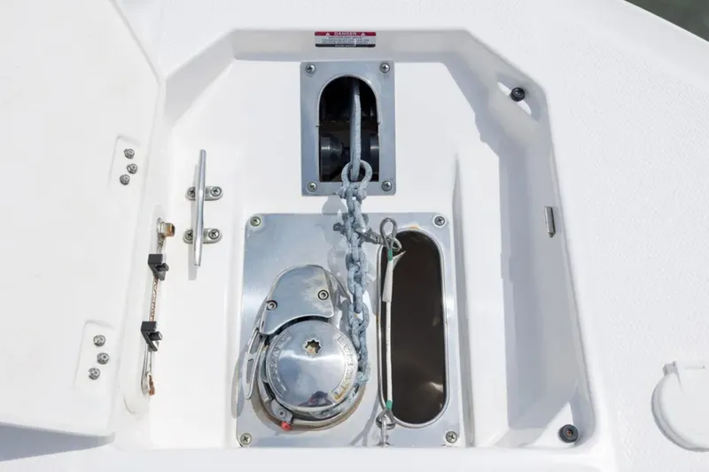 Slide: The Image of Anchor compartment of 2021 Robalo R272 Center Console boat with chain and winch. - 17