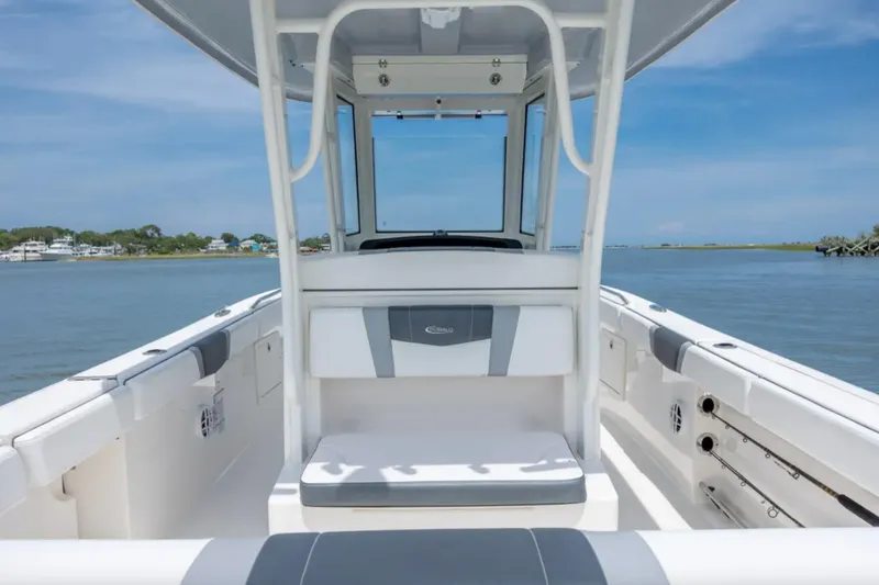 Slide: The Image of 2021 Robalo R272 Center Console boat interior with seating, on calm water. - 14