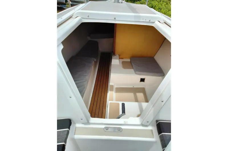 Slide: The Image of Interior view of a 1980 MacGregor 25 sailboat cabin with wooden flooring. - 11