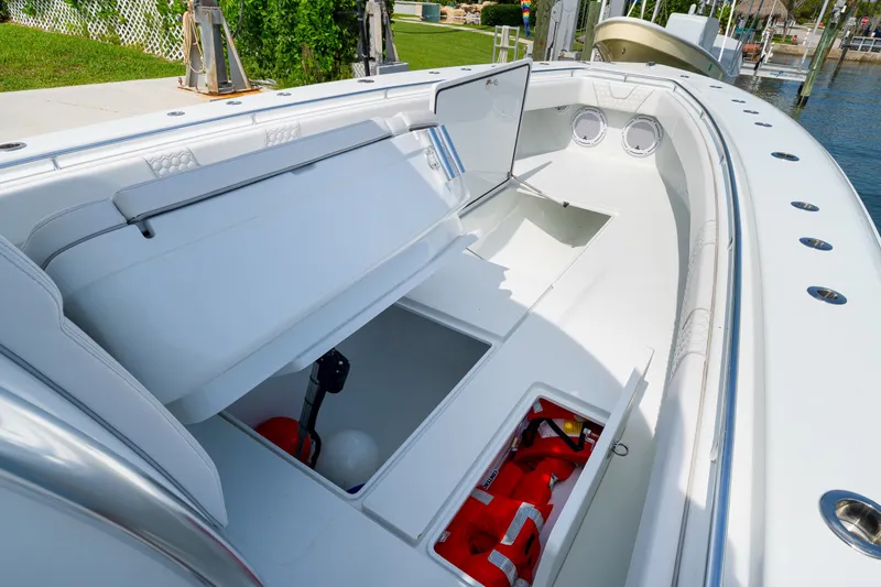 Slide: The Image of 2026 Contender 44 ST boat interior with open storage compartments and safety equipment. - 25