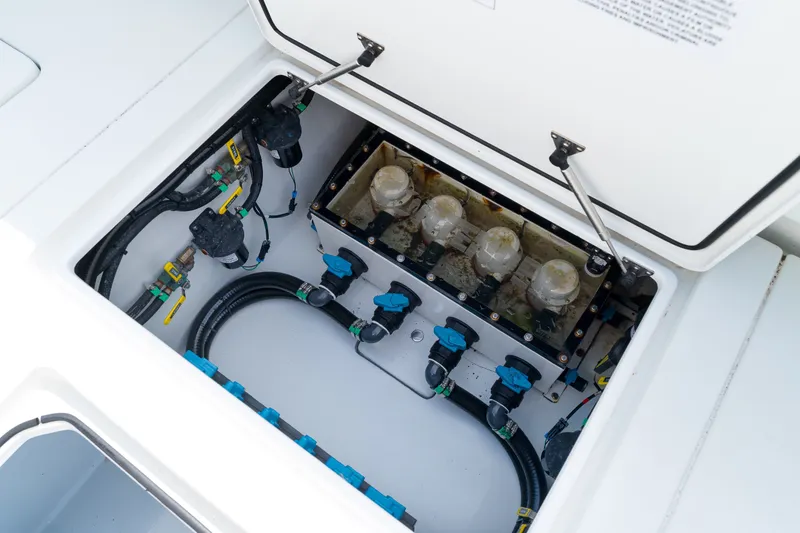 Slide: The Image of 2026 Contender 44 ST boat compartment with visible wiring and components. - 31