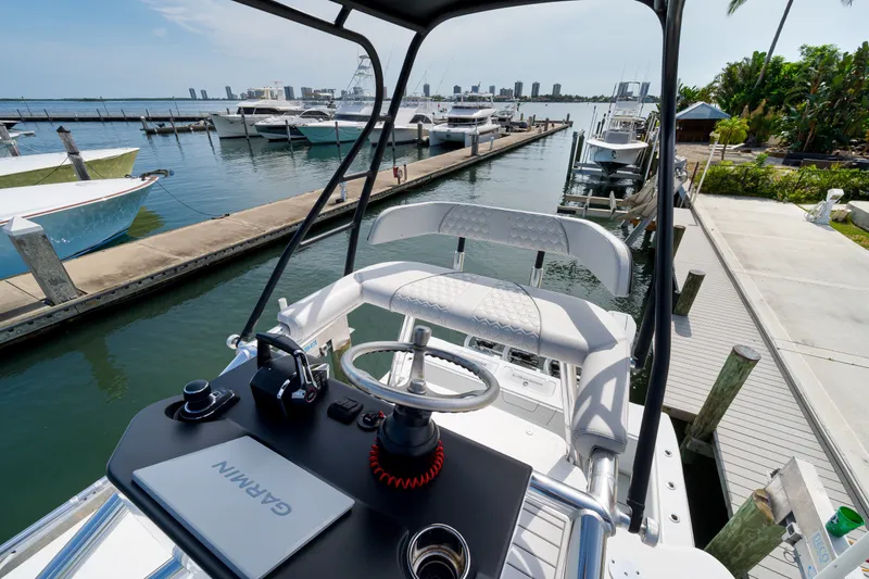 Slide: The Image of 2026 Contender 44 ST boat at marina, featuring Garmin navigation system and sleek design. - 32