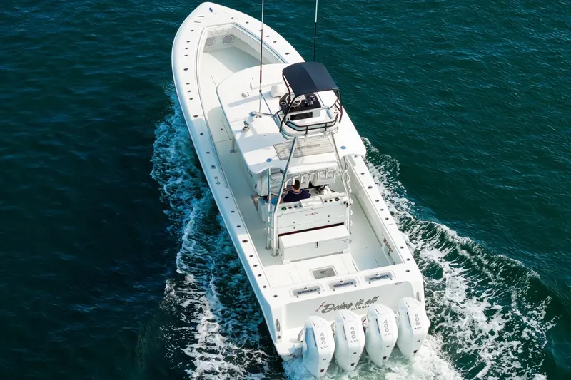 Slide: The Image of 2026 Contender 44 ST boat cruising on open water, featuring four powerful engines. - 5