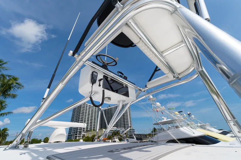 Slide: The Image of 2026 Contender 44 ST boat with sleek design and modern equipment, docked under clear skies. - 34
