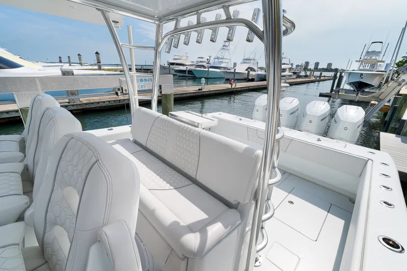 Slide: The Image of 2026 Contender 44 ST boat with luxurious seating and powerful engines docked at marina. - 18