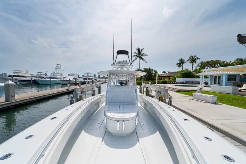 Slide: The Image of 2026 Contender 44 ST boat docked at marina, surrounded by palm trees and clear skies. - 35