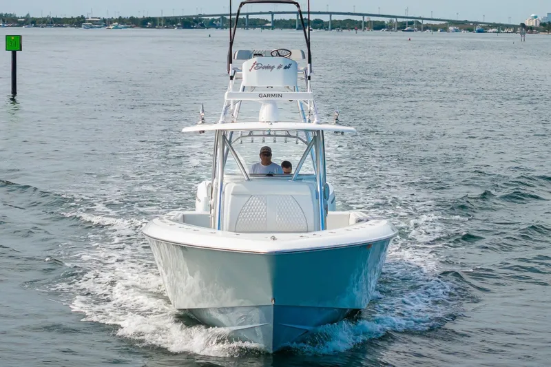 Slide: The Image of 2026 Contender 44 ST boat cruising on open water, showcasing sleek design and performance. - 8