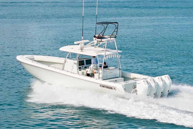 Slide: The Image of 2026 Contender 44 ST boat cruising on open water with four powerful engines. - 11