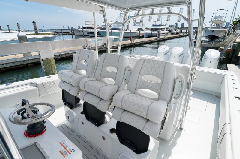 Slide: The Image of 2026 Contender 44 ST boat interior with luxurious seating at a marina. - 17