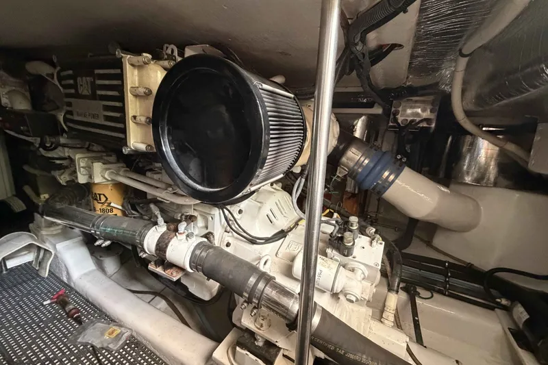 Slide: The Image of Engine room of a 2000 Riviera 48 Convertible yacht, featuring a CAT marine engine. - 20
