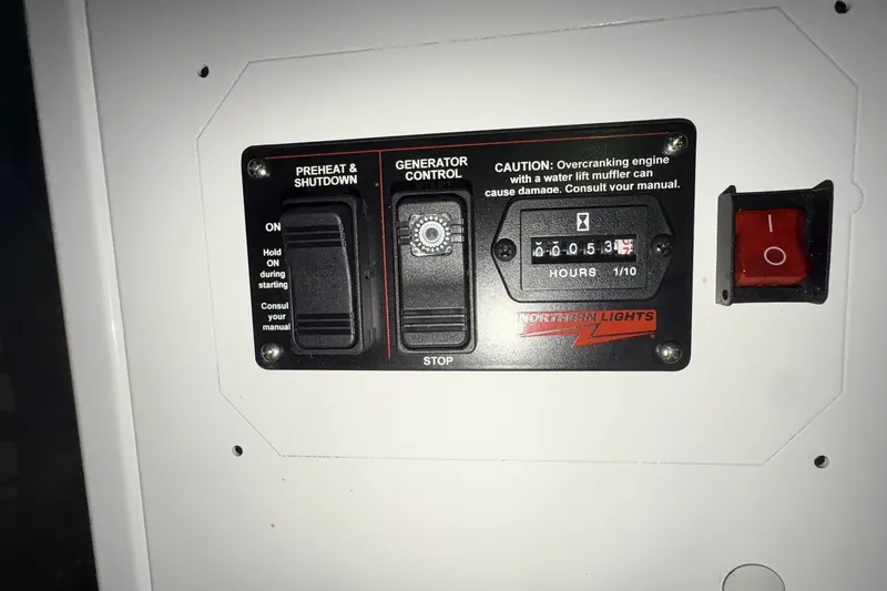 Slide: The Image of Control panel of a 2000 Riviera 48 Convertible boat with generator controls and hour meter. - 7