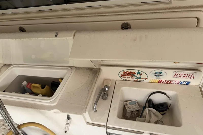 Slide: The Image of Interior view of a 2000 Riviera 48 Convertible boat with storage compartments and stickers. - 10