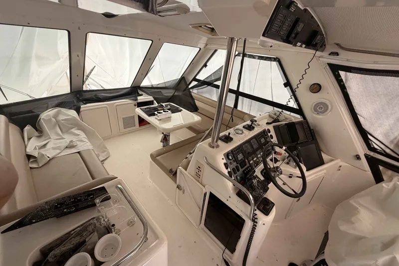 Slide: The Image of Interior of a 2000 Riviera 48 Convertible yacht, featuring helm and seating area. - 11