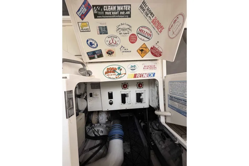 Slide: The Image of Engine room of a 2000 Riviera 48 Convertible with various stickers and control panel. - 6