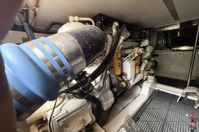 Slide: The Image of Engine room of a 2000 Riviera 48 Convertible yacht, showcasing mechanical components. - 19