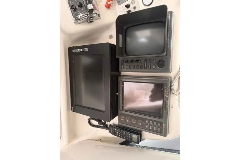 Slide: The Image of Control panel of a 2000 Riviera 48 Convertible yacht with navigation equipment. - 13