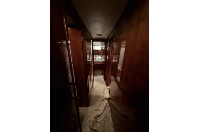 Slide: The Image of Interior hallway of 2000 Riviera 48 Convertible yacht with wooden paneling. - 16