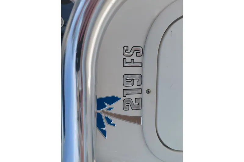 Slide: The Image of 2024 Key West 219 FS boat emblem with blue logo and metallic finish. - 39