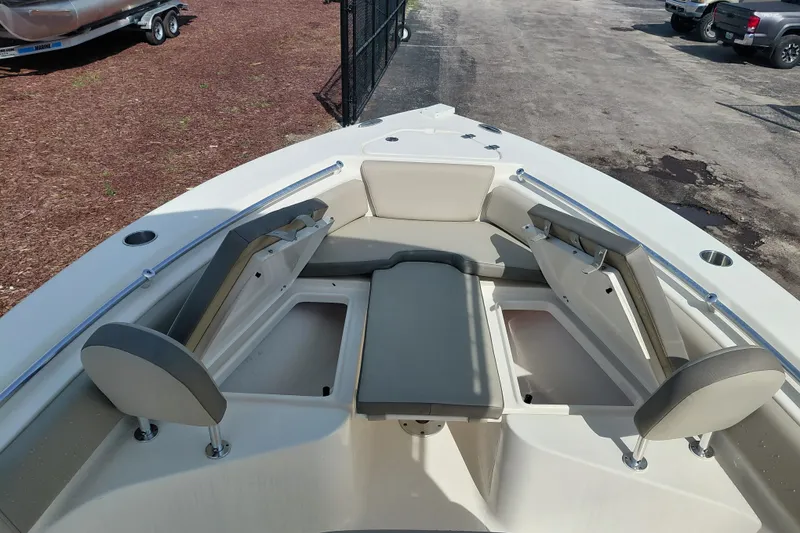 Slide: The Image of 2024 Key West 219 FS boat interior with cushioned seating and storage compartments. - 14