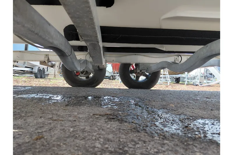 Slide: The Image of Underside view of 2024 Key West 219 FS boat trailer with visible wheels and frame. - 40