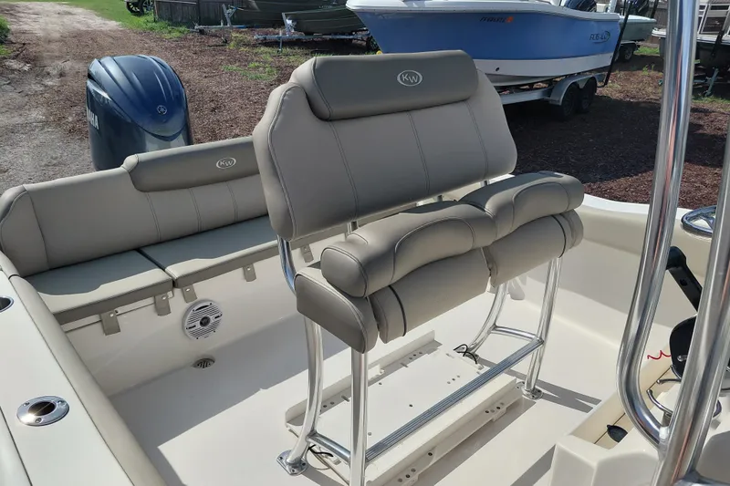 Slide: The Image of 2024 Key West 219 FS boat interior with cushioned seating and Yamaha engine. - 23