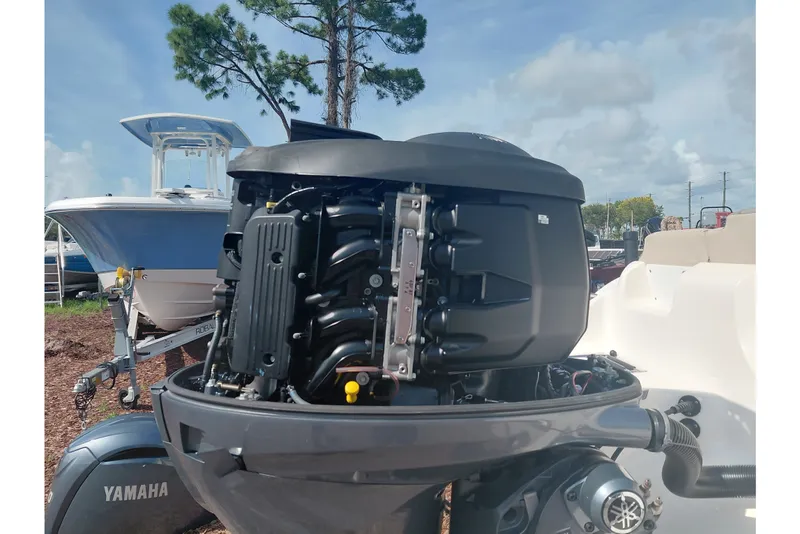 Slide: The Image of 2024 Key West 219 FS boat with Yamaha outboard engine, displayed outdoors. - 41
