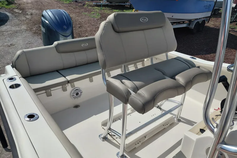 Slide: The Image of 2024 Key West 219 FS boat interior with cushioned seating and Yamaha engine. - 24