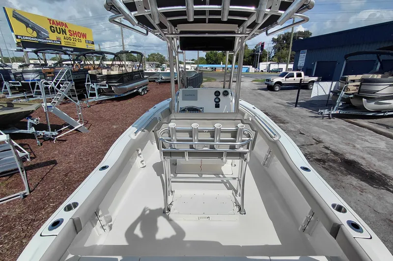 Slide: The Image of 2024 Key West 219 FS boat interior with console and rod holders, displayed outdoors. - 34