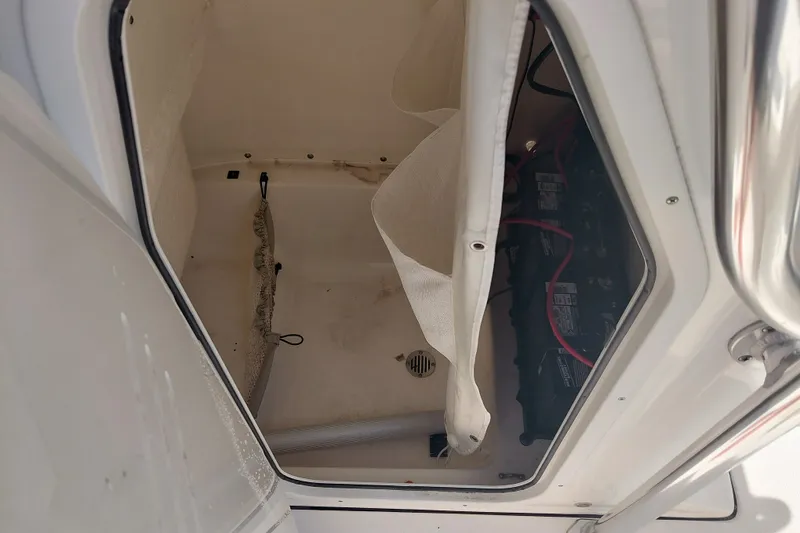 Slide: The Image of Storage compartment of 2024 Key West 219 FS boat, featuring battery and wiring. - 20
