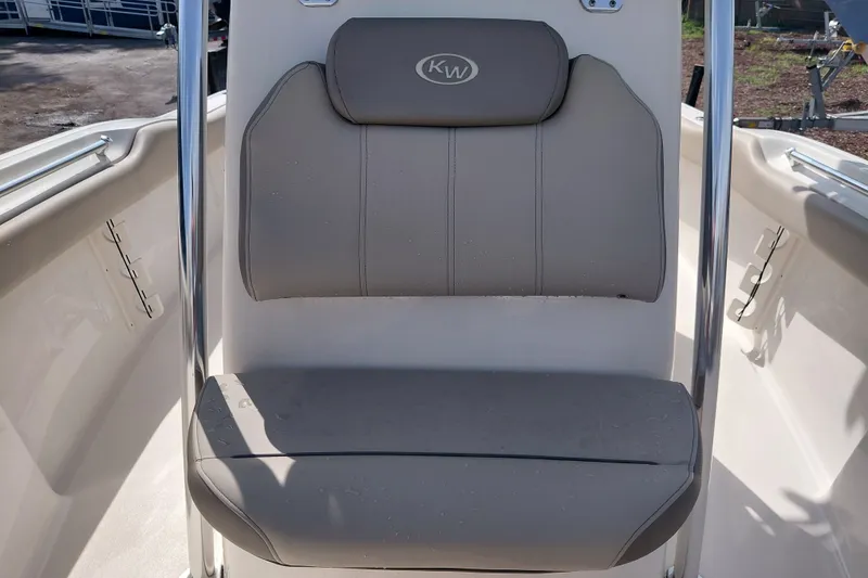 Slide: The Image of 2024 Key West 219 FS boat seat with beige upholstery and chrome accents. - 16
