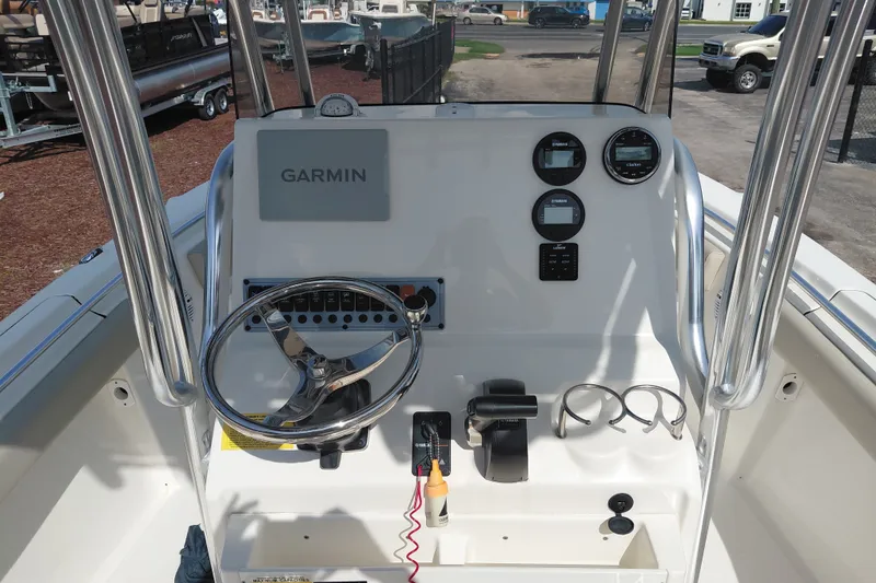 Slide: The Image of 2024 Key West 219 FS boat console with Garmin navigation and steering wheel. - 25