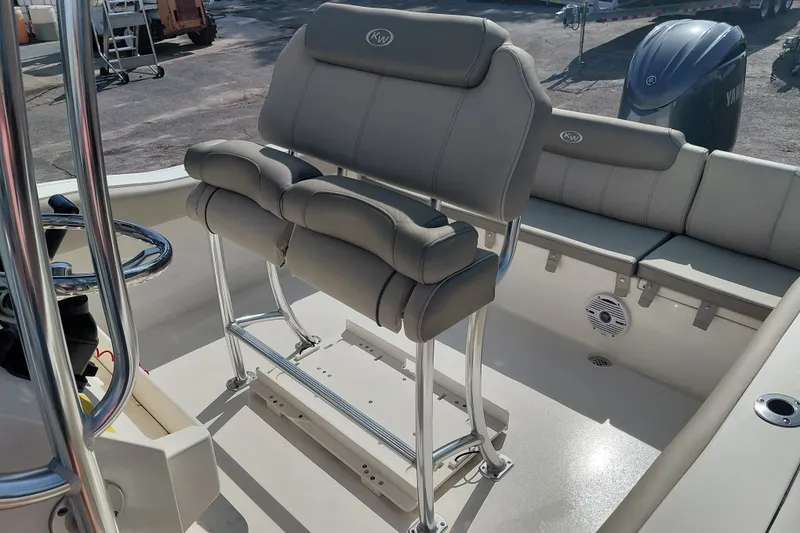 Slide: The Image of 2024 Key West 219 FS boat interior with cushioned seating and steering console. - 22