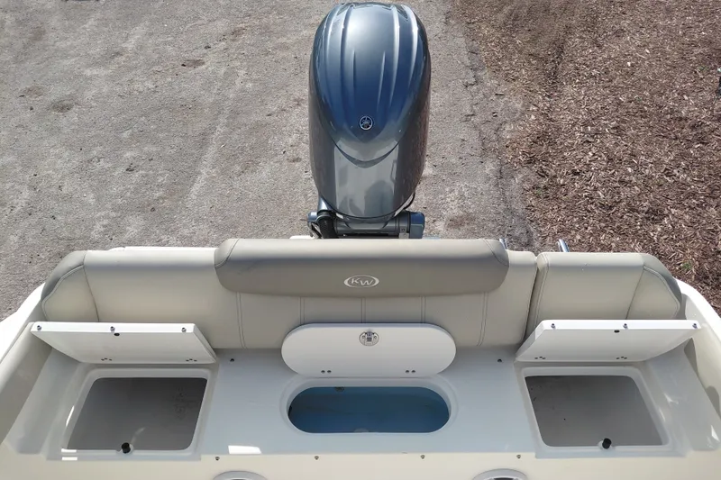 Slide: The Image of 2024 Key West 219 FS boat stern view with motor and seating area. - 30