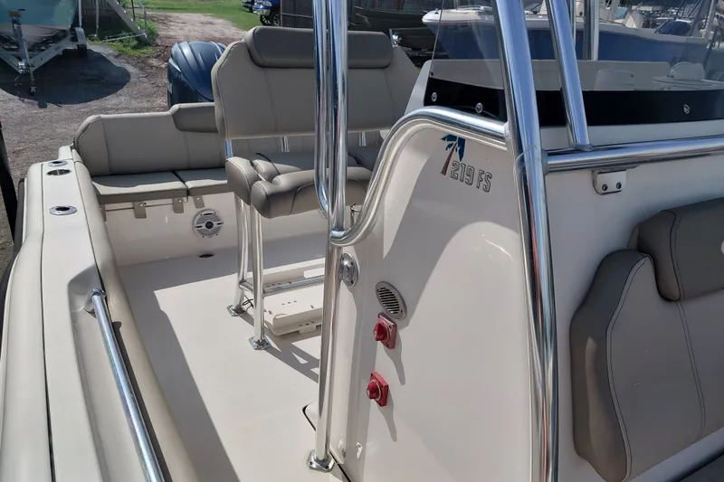 Slide: The Image of 2024 Key West 219 FS boat interior with seating and console details. - 18