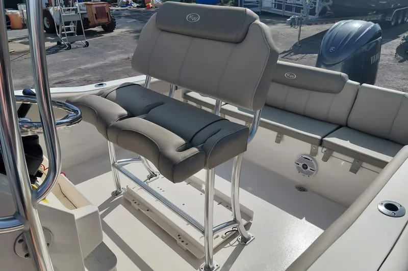 Slide: The Image of 2024 Key West 219 FS boat interior with cushioned seating and steering console. - 21