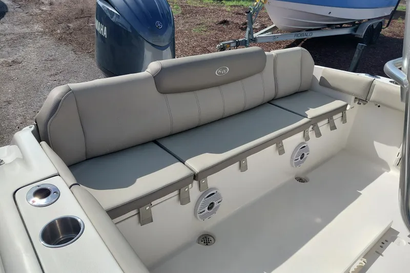 Slide: The Image of 2024 Key West 219 FS boat interior with cushioned seating and Yamaha engine. - 27