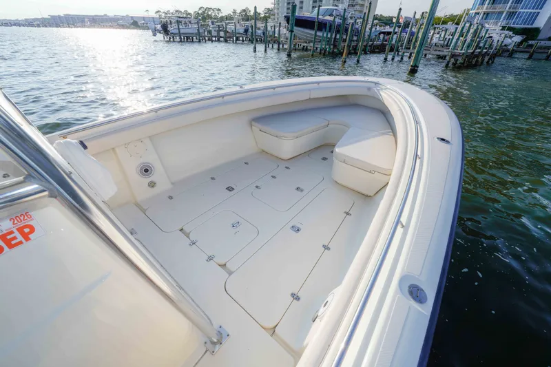 Slide: The Image of 2005 Pursuit 3480 Center Console boat docked, featuring spacious deck and seating area. - 30