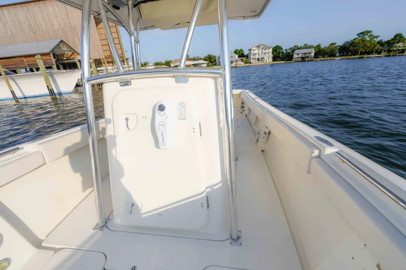 Slide: The Image of 2005 Pursuit 3480 Center Console boat on calm waters, showcasing spacious deck and sturdy design. - 39
